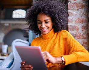 Young woman using a tablet for banking.