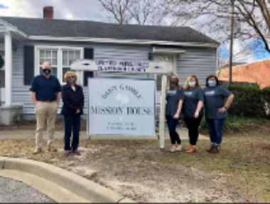 Group of four women and one man in front of United Ministries of Clarendon County, SC